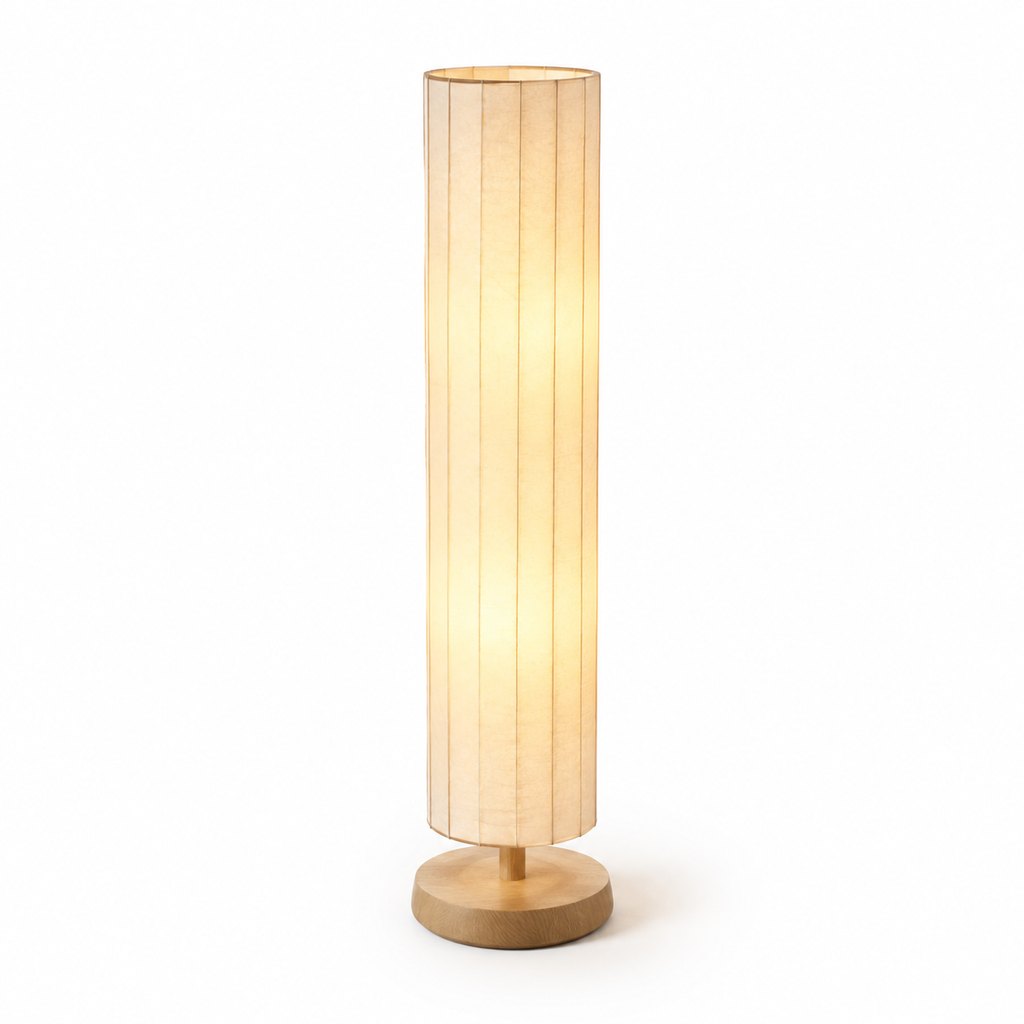 Akari rice-paper floor lamp with oak base glowing warmly in a dim room — view 2